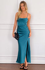 Blonde model wearing an emerald green formal maxi dress with gold jewellery and black heels