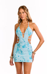 Model wears a blue beaded halter neck mini dress. This eye-catching party dress features all-over embellishment and a bodycon fit. A perfect dress for a birthday or homecoming celebration.