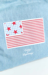 Model wearing a denim tote bag with a red and blue USA flag applique