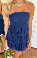 A festive navy blue strapless mini dress- featuring a ruched bodice and a tiered- ruffled tulle skirt- ideal for a party or homecoming celebration.