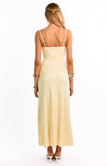 The back of a yellow lace formal dress shown on a girl. This elegant maxi dress highlights the delicate all-over lace pattern and adjustable spaghetti straps. A romantic choice for homecoming or a special occasion.