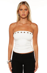 Close up view of a white strapless tube top with gold eyelet details a stylish choice for a night out this Spring