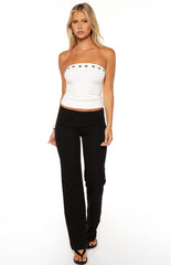 Model wearing a white strapless top with eyelet detail styled with black trousers a perfect outfit for a Summer evening
