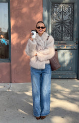 Smiling girl in a cozy beige faux fur coat a stylish and warm layer for a cool Fall evening