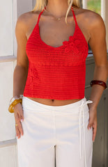 Close up angle of the Kiki red Crochet Flower Halter top which features a halter neckline and textured crochet flowers. This top is a gorgeous choice for the summer time and festivals!