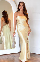 brunette model wearing yellow satin strapless maxi dress with leg split and ruffle detail