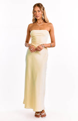 A model in a yellow strapless maxi dress with an elegant straight neckline. This sophisticated formal dress features a sleek column silhouette. An ideal choice for a wedding guest or graduation ceremony.