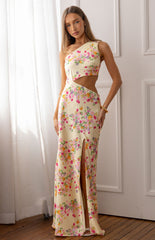 Model wears a yellow floral satin maxi dress with a cowl neckline for a wedding guest outfit.
