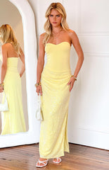 blonde model wearing a strapless yellow gown with a jersey stretch bodice and sequin skirt
