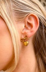 gold plated push back earrings with a bow detail and dangly heart