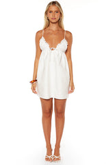 Model wearing a cute white tie-front mini dress with thin straps a perfect simple look for a Summer day