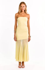 Model wears a stunning yellow strapless maxi dress. This formal gown features a fitted bodice and an asymmetrical ruffle hem. The perfect prom dress or wedding guest outfit.