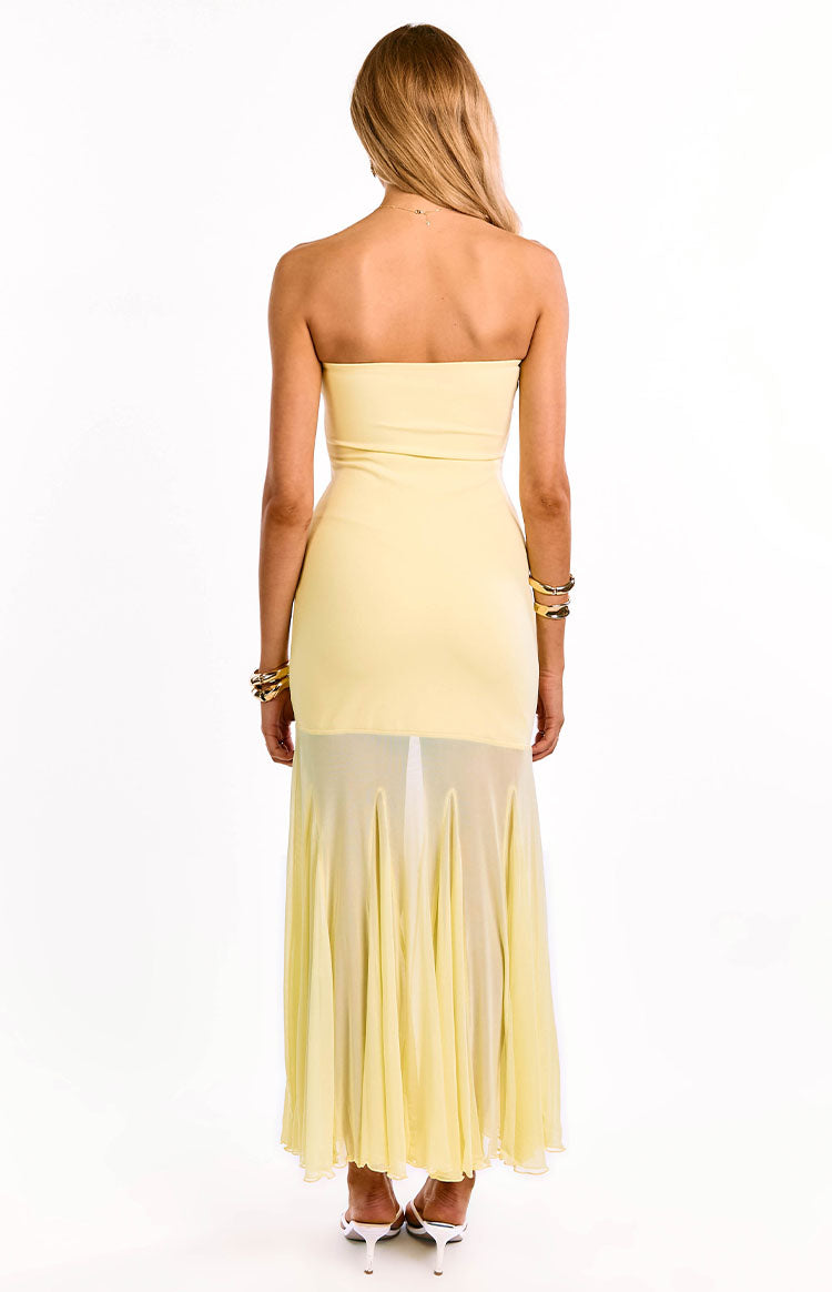 A girl wears a yellow strapless formal gown showing its open back. This stunning party dress highlights the cascading ruffle on its high-low hem. An elegant choice for homecoming or special events.