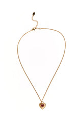 A delicate gold necklace featuring a single red heart pendant. This simple accessory elevates a casual weekend outfit or a special date night look. The pendant has a bright polished finish.