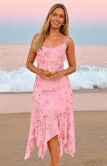 A soft pink midi-dress with thin spaghetti straps- featuring a floral print with beaded details and a flowing- handkerchief-style hemline. This dress is suitable for a summer event or a special occasion.