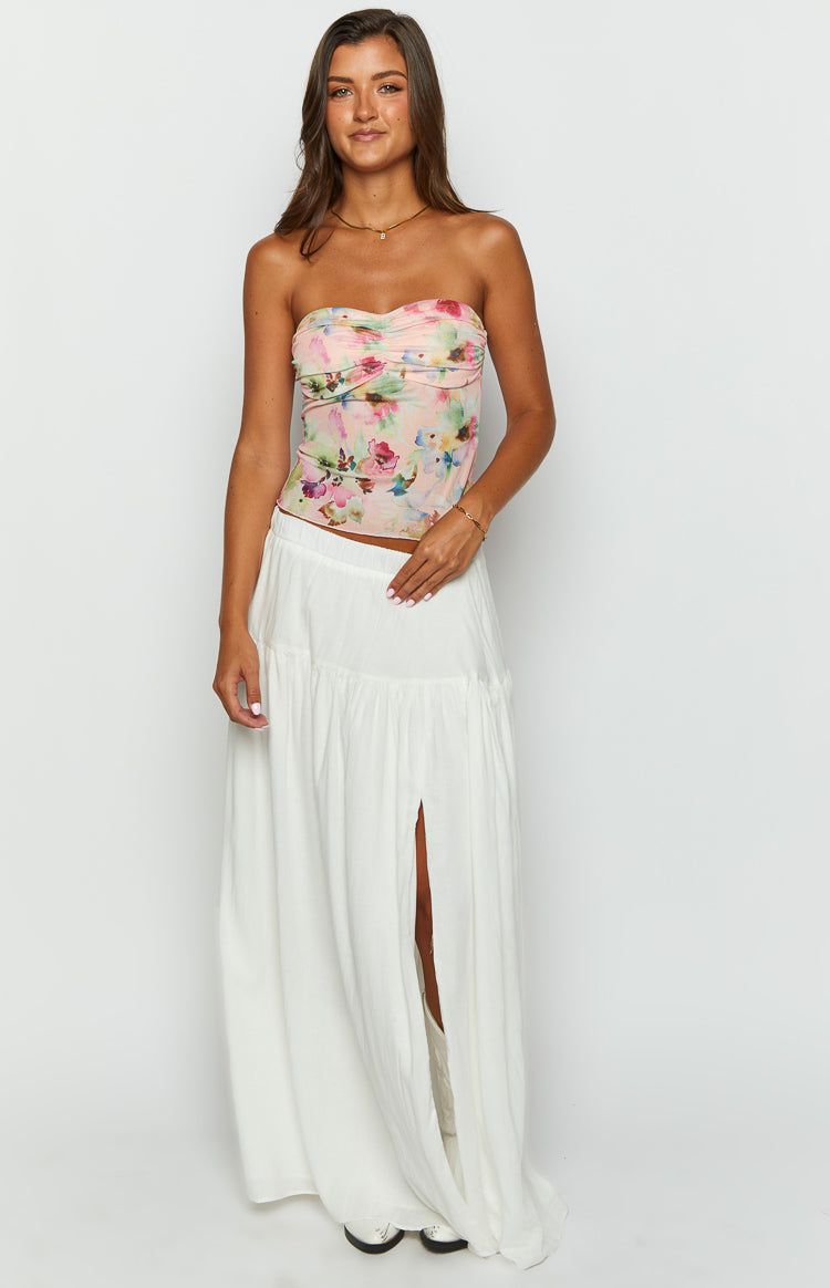 pink floral strapless top and white tiered maxi skirt on brunette model