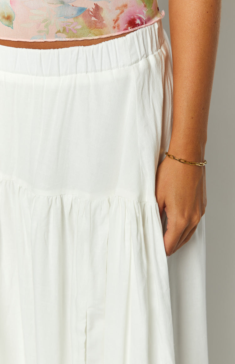 gold chain bracelet and white tiered maxi skirt on model