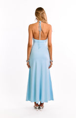 The open back of a light blue halter maxi dress is shown on a girl. This beautiful evening gown features a figure-hugging fit through the body. Ideal for formal events or special occasions.