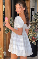 White mini dress with puffy capped sleeves on brunette model