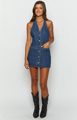 Blue denim halter neck mini dress and black sparkly cowboy boots on brunette model
