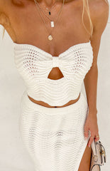 cream knit top on model paired with matching midi skirt