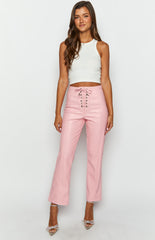 pink leather pants with corset tie up on brunette model