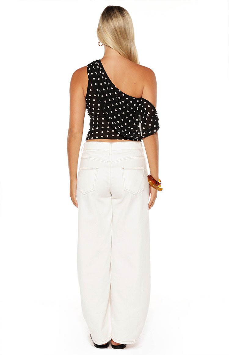 Model wearing a crisp white off-shoulder crop top and white wide-leg jeans perfect for a fresh Spring look
