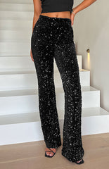 Black high-waisted sequenced pants at ankle length on model