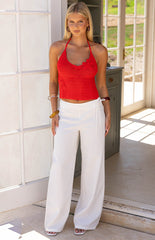 Girl showcasing the elegant wide leg silhouette of the Jacq White Tie Waist Pants an elevated choice for a beach vacation or a sophisticated day event.