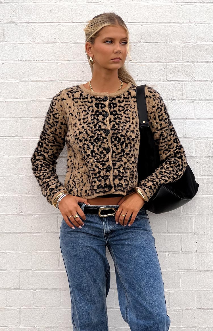 Woman wearing a textured tan and black leopard print button-up cardigan