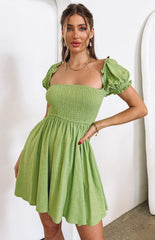 Flowy green mini dress style on model Belle Lucia.