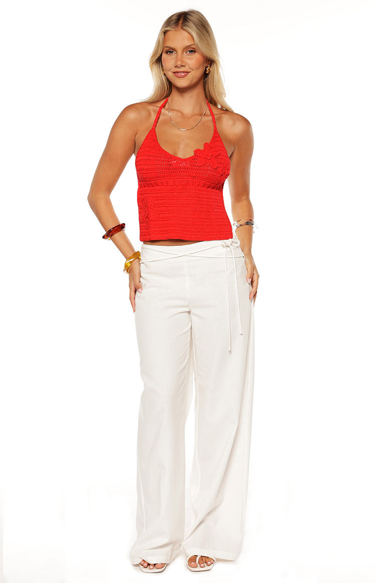 Model wears the Kiki Red Crochet Flower Halter Top a statement piece perfect for a summer festival or a beach party.