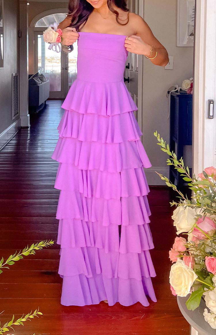 Girl wearing a purple strapless tiered formal gown for prom