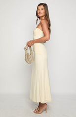 Blonde model wearing a strapless cream mesh maxi dress with ruched details through the bodice