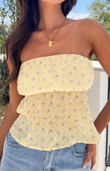 Yellow floral strapless top on brunette model