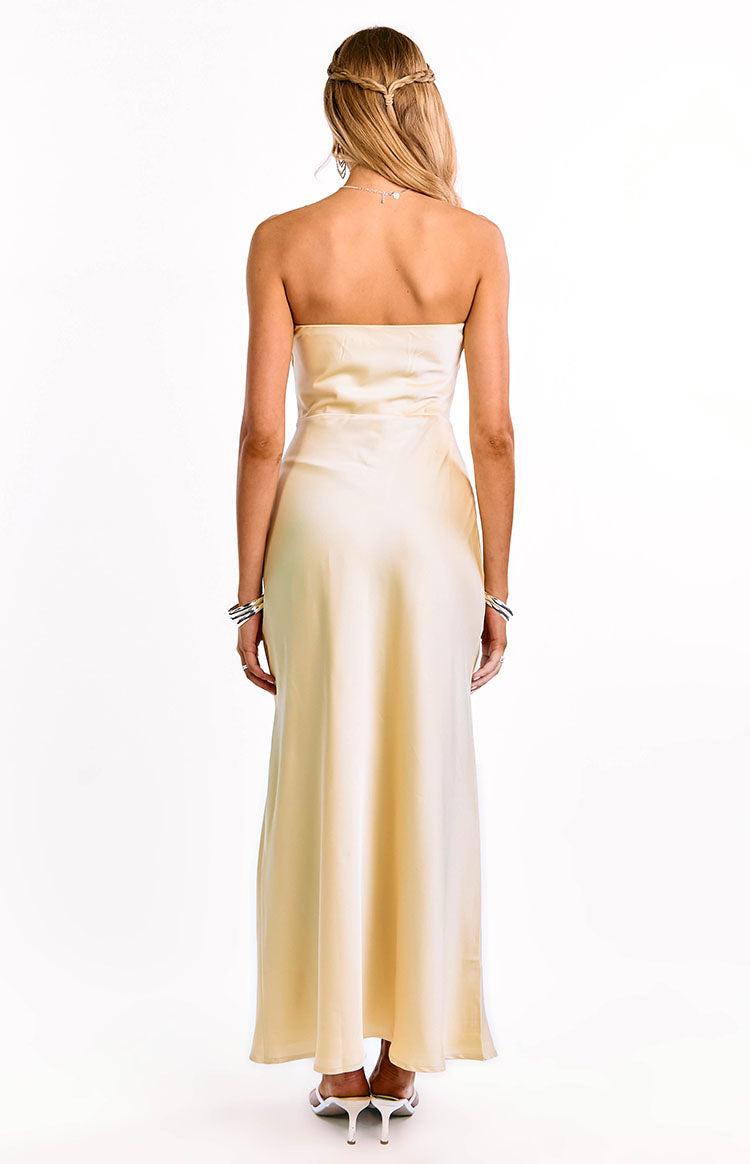 The back of a yellow strapless formal gown is shown on a girl. This evening dress highlights a beautiful satin material. A timeless and elegant option for prom or a special occasion.