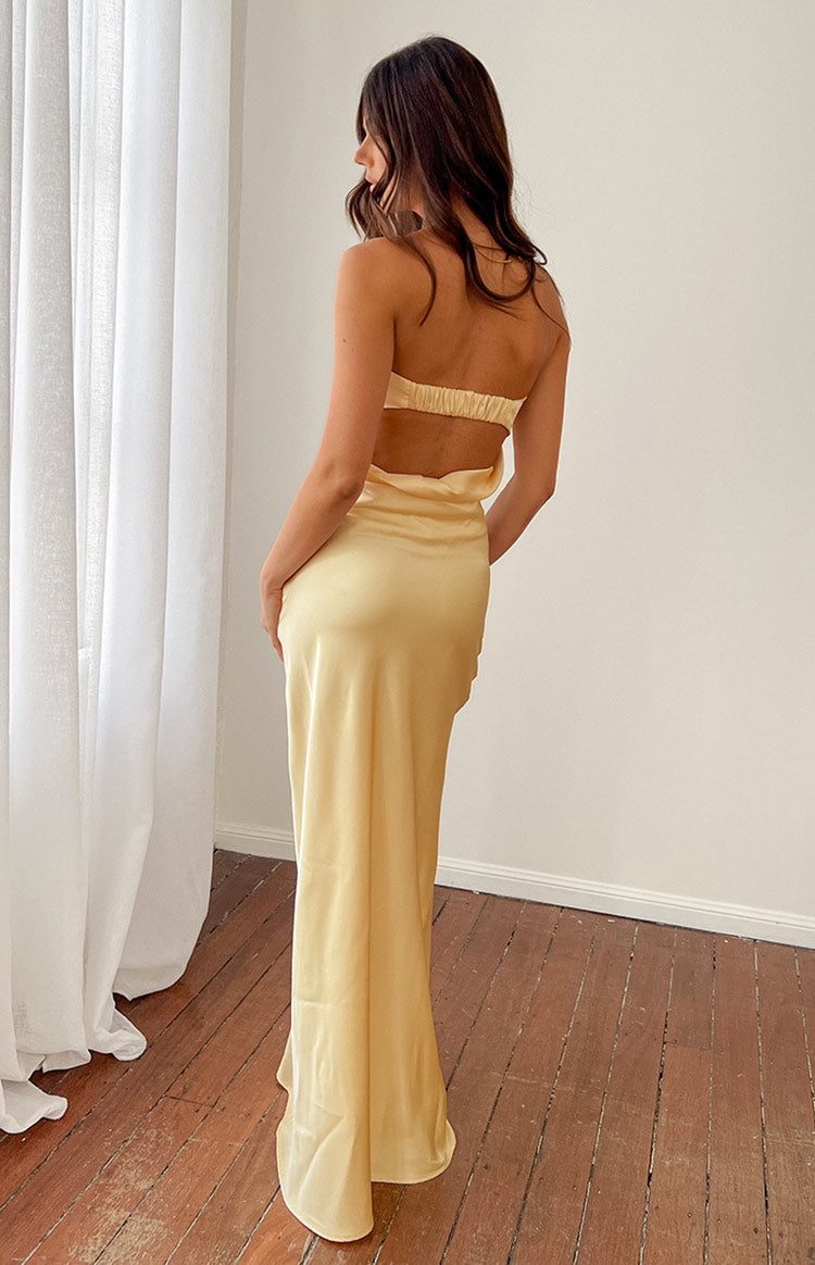 Strapless yellow formal maxi dress on brunette model.