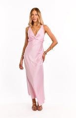 Model wears a light pink v-neck maxi dress. This romantic formal dress features a gathered bust and a flowy A-line skirt. A beautiful option for a wedding guest or special occasion.