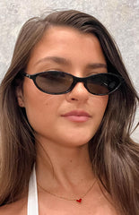 brunette model wearing black cateye frames sunglasses with smokey black lenses
