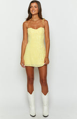 yellow sparkly sequin mini dress with adjustable tie up spaghetti straps on brunette model