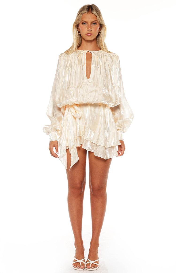 Model in a beautiful pearl satin mini dress with long bishop sleeves a romantic look for a special occasion or date night