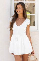 Girl wearing the Raldo White Playsuit a versatile and effortless one piece outfit for a polished summer look.