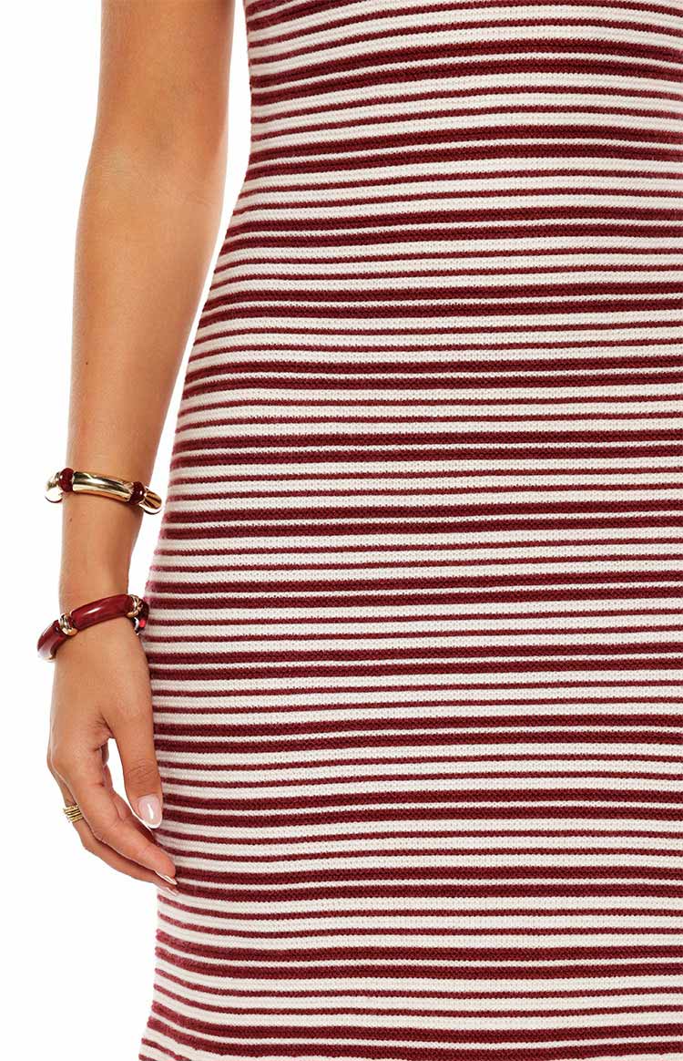 Model in the Rhiannon Burgundy Stripe Knit Maxi Dress a flattering bodycon style perfect for a casual evening out or a weekend event.