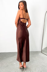 Brown satin maxi dress with clasp at back worn by brunette model with nude heels.