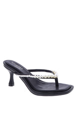 A pair of black low heels with a thong strap pearl details and a modern square toe.