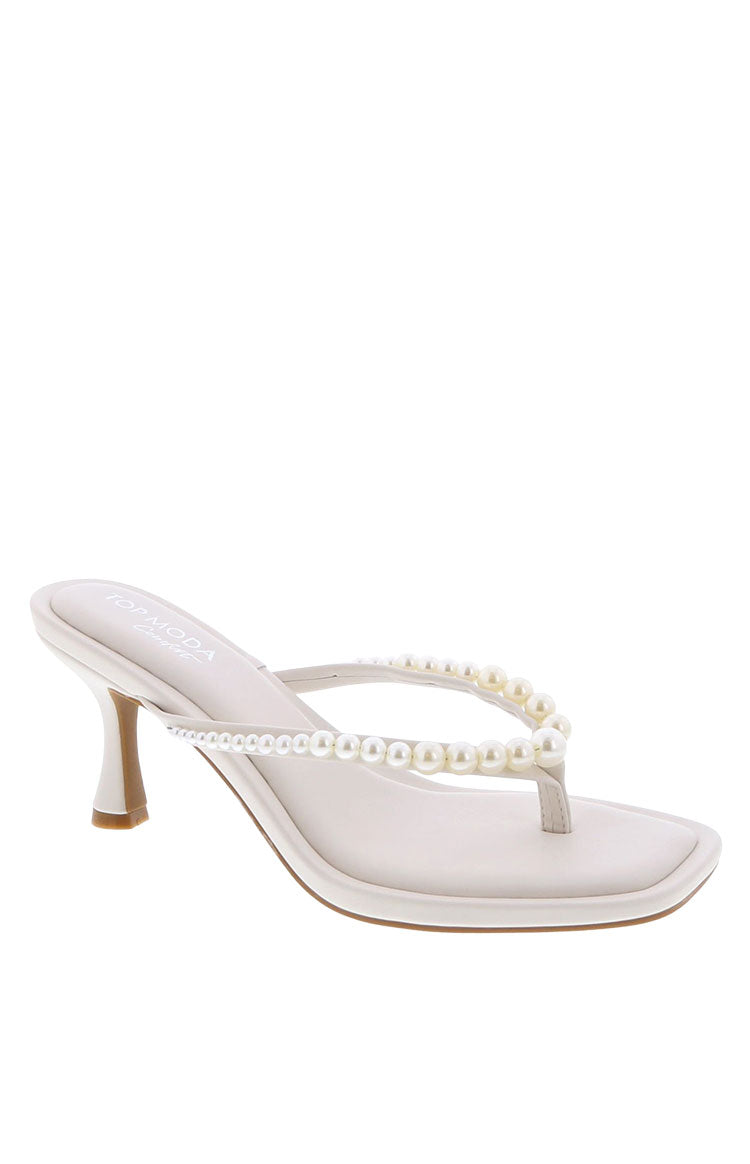 A pair of ivory thong heels featuring pearl embellishments a square toe and a low block heel.