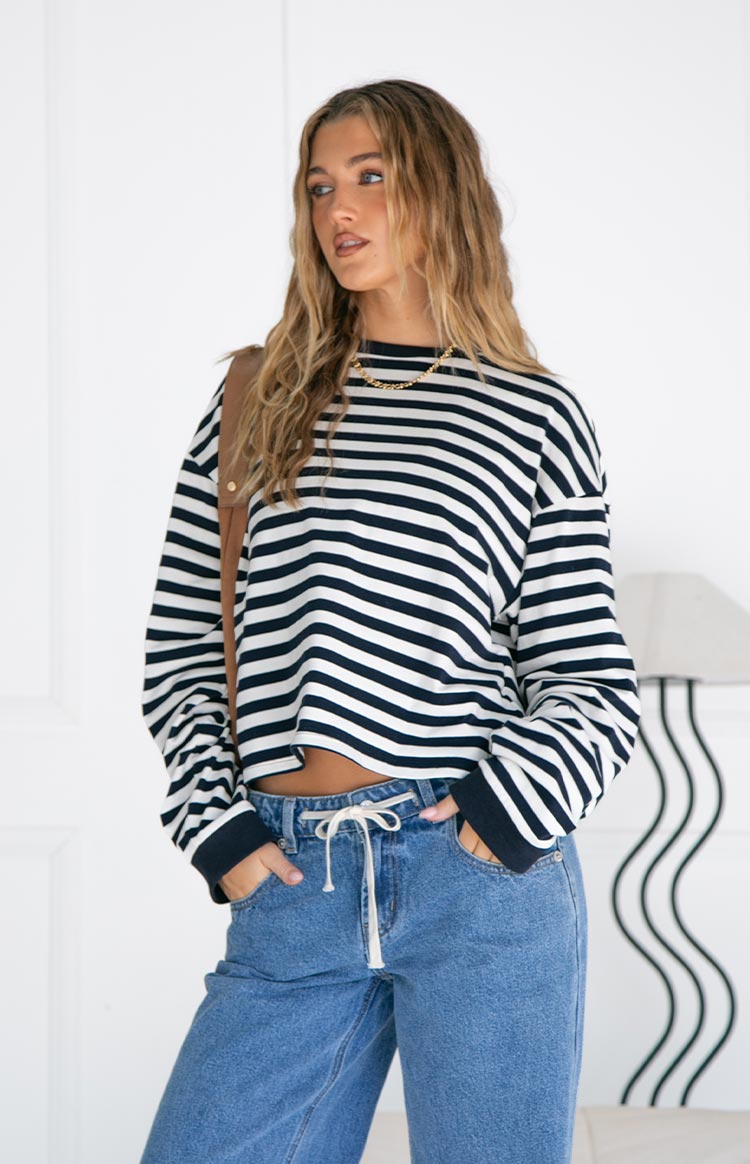 Model wearing a black and white striped long-sleeve top