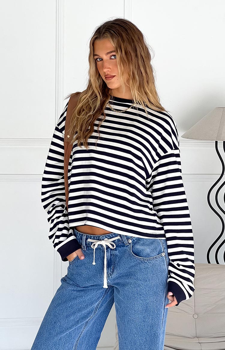 Model wearing a black and white striped long-sleeve top