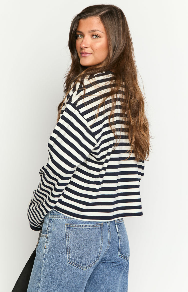 Model wearing a black and white striped long-sleeve top