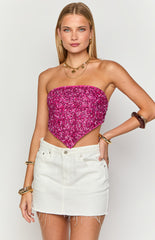paired with white textured shorts and holding a small white woven handbag.